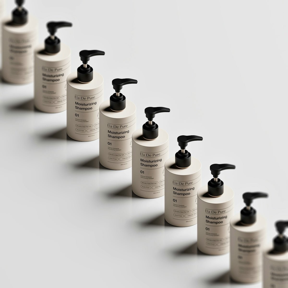 A diagonal row of beige shampoo bottles with black pump dispensers on a white surface.