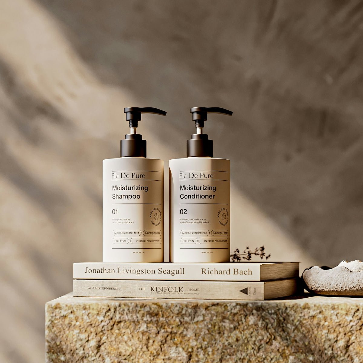 Two pump bottles of moisturizing shampoo and conditioner.