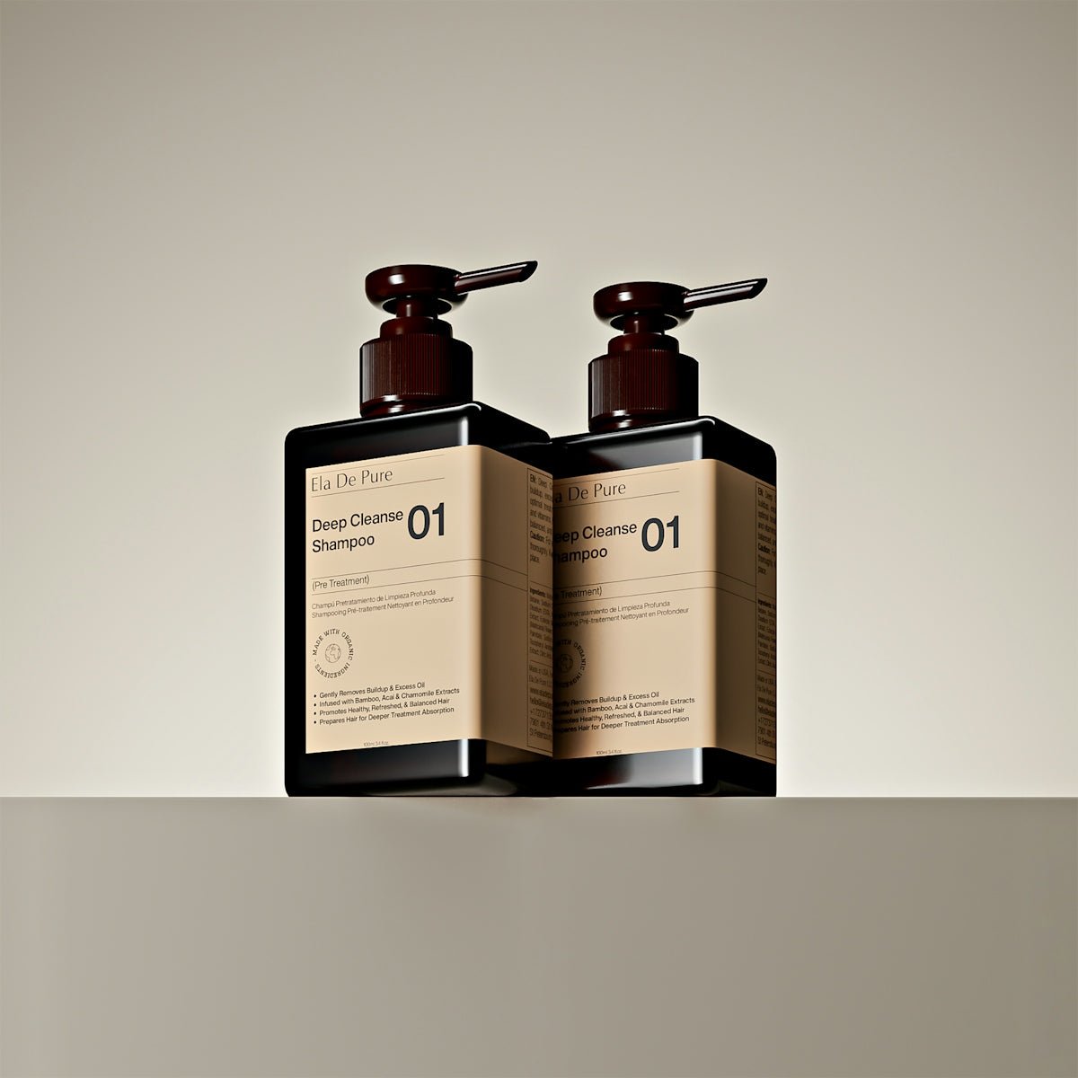 Two dark bottles with pumps on a shelf.